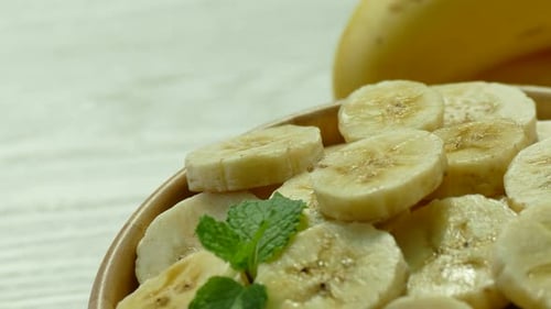 Sliced Bananas in a Bowl with Mint