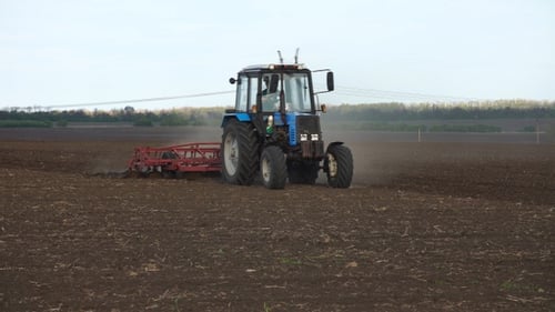 Tractor plows the farm field