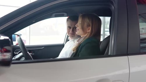 Woman and Man in Car at Dealership