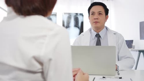 Doctor Talking with Patient in Medical Office