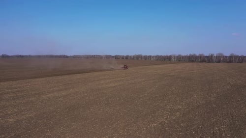 Red Tractor On The Field Working Aerial View