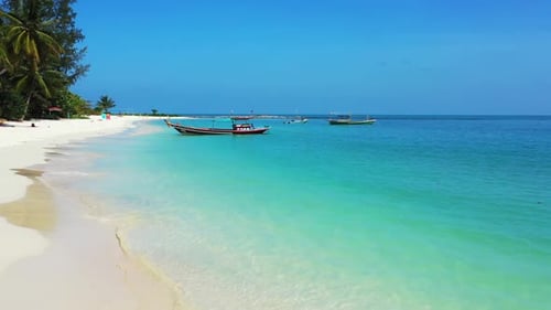 Aerial top view sky of beautiful tourist beach trip by blue green water with white sandy background