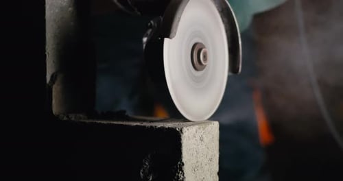 Anonymous Contractor Cutting Lines on Concrete Brick