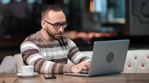 Busy Business Guy Working Surfing Internet on Laptop Pc at Cafe