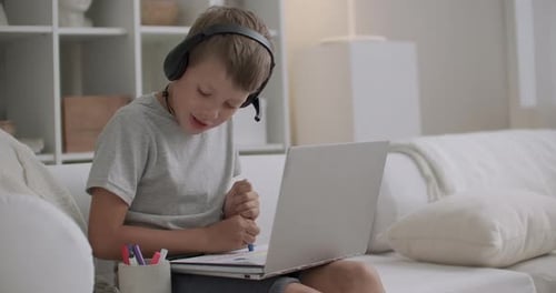 Boy Drawing with Markers During Online Learning