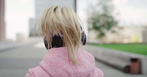 Rear view of jogging woman in the city