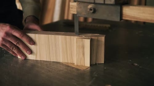 A Worker in the Workshop Cuts Out a Small Bar Shapes It Using Electric Equipment