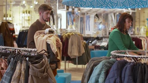 Couple Shopping for Fashionable Clothing in Retail Store