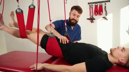 Patient Receiving Physiotherapy Treatment with Sling Suspension