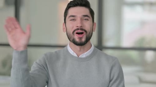 Portrait of Young Man Waving Welcoming