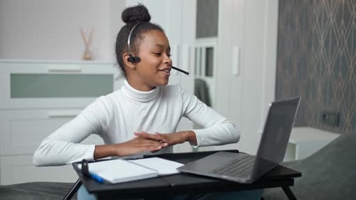 Teen Studying Online Using Laptop in Bedroom