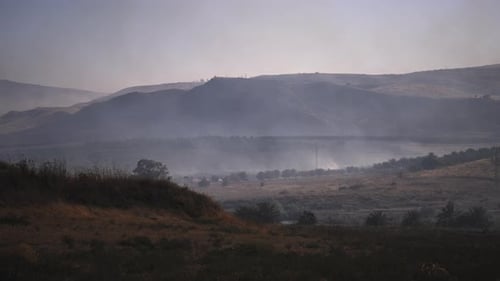 Wildfire spreading above the field