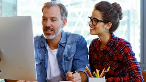 Man and Woman Working at a Desktop Computer