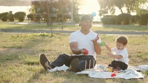 Thai Father Iand Son Are Playing Educational Games in the Park