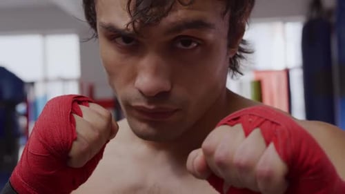 Front view of caucasian man in boxing gym