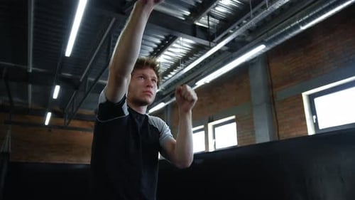 Serious Kickboxer Warming Up Hands at Gym. Fighter Training in Fitness Center