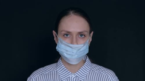 Woman Wearing Surgical Mask Over Eyes and Face