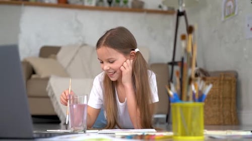 Young Child Paints in Her Home Art Studio
