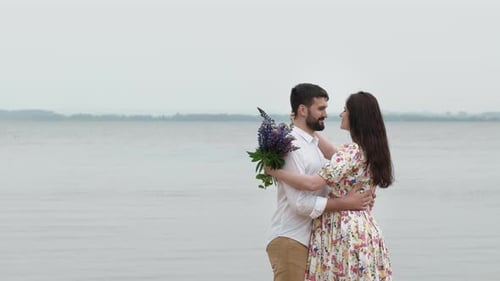 Loving Couple Embraces on a Calm Beach