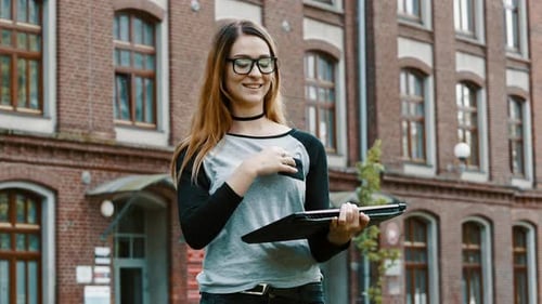 Redhead Woman in Glasses Standing and Working on Laptop, Looking at Camera, Girl on College