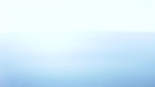 A Transparent Drop of Water Falls on the Surface of a Liquid in Slow Motion.