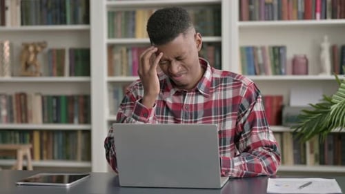 Man at Computer Experiences Headache