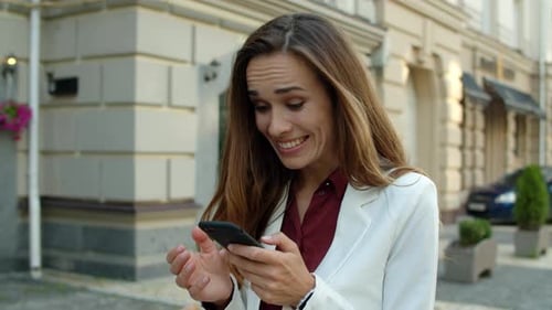 Excited Woman Sees Good News on Mobile Phone