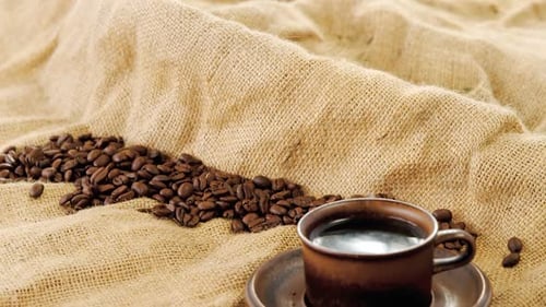 Coffee Beans and Coffee Cup on Burlap Sack