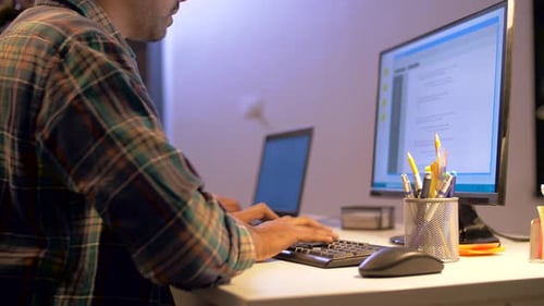 Programmer with Computer Working at Night Office 80
