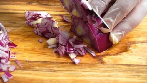Hands Mincing Red Onion on Cutting Board