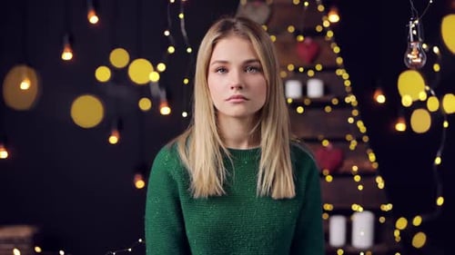 Girl in Green Sweater in front of Lights
