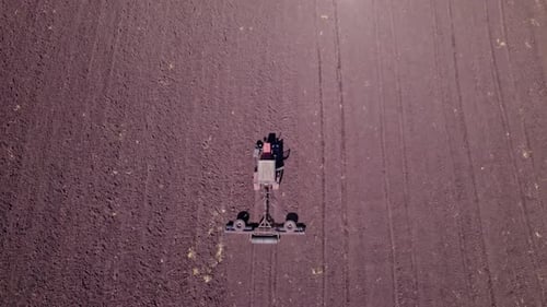 Tractor in the Dust Working in the Field