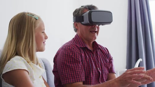 Adult and Child Exploring Virtual Reality Together Indoors