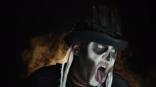 Man in Costume Makeup Screaming in Dark Setting