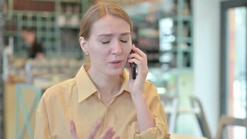 Woman Talking Angrily on Smartphone Indoors