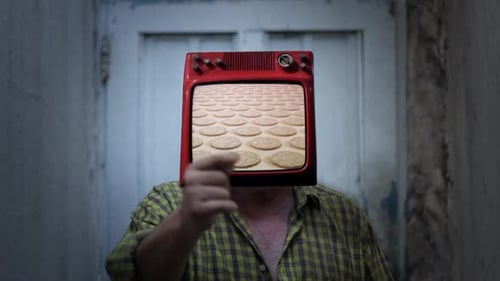 Person with Television Head Displaying Cookies