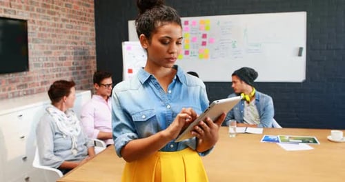 Woman Using Tablet in a Meeting Room