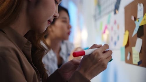 Business people brainstorming meeting working sharing data and writing board in night office