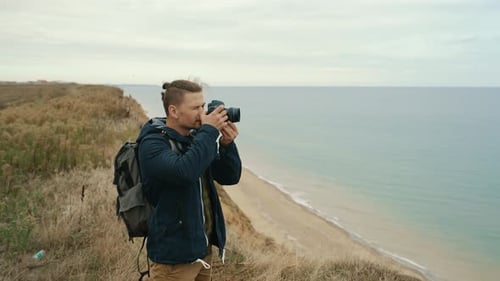 Young Adult Taking Photos of Ocean Views