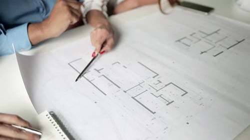 Business People Discussing Building Floor Plan