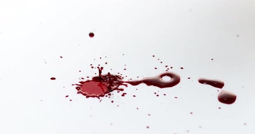 Red Liquid Drops Splattering on White Background
