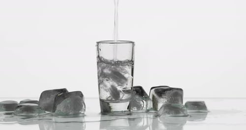 Shot Glass Being Filled Near Ice