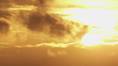 Dramatic Golden Light Through Cloudscape at Sunset