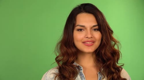 A Young Beautiful Caucasian Woman Smiles at the Camera Closeup Green Screen Background