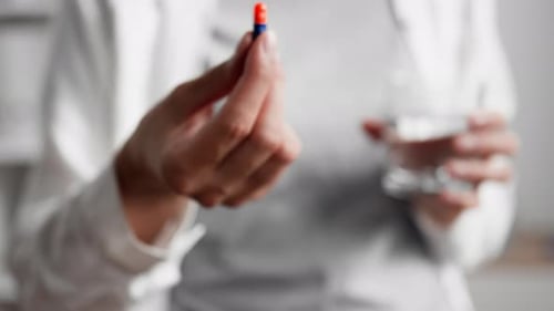 The Hand Holds Out A Pill Capsule Close Up Of A Bright Capsule In The Patient's Hand Treatment Pills