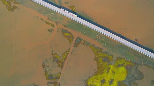 Drone video of the road leads through a large beautiful wetland.
