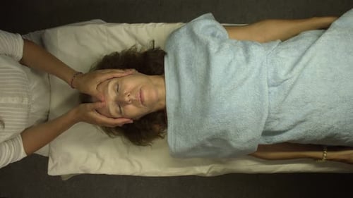 Woman Receives Relaxing Facial Massage at Spa