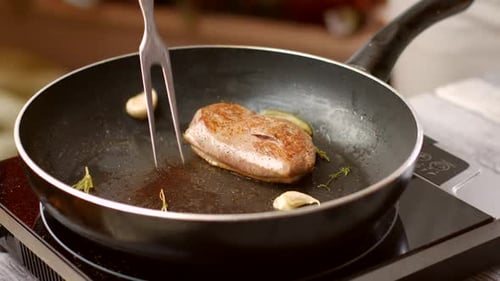 Juicy Steak Cooking with Garlic and Rosemary