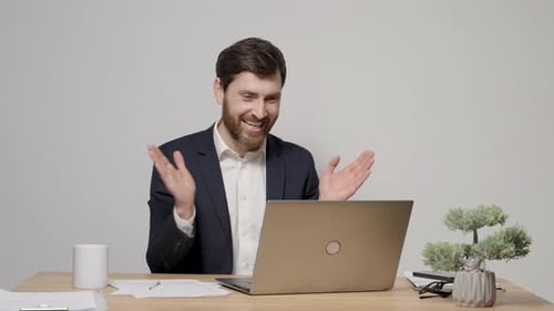 Happy male office employee in formal wear raising fists in triumph, celebrate good news