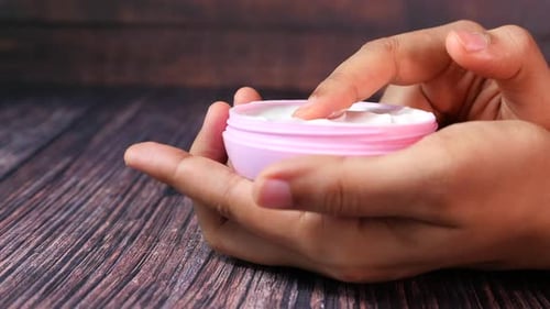 Woman Applying Beauty Cream Onto Skin at Home Close Up